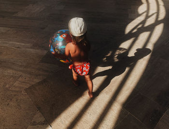 High angle view of girl standing on floor