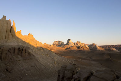 Scenic view of desert against clear sky