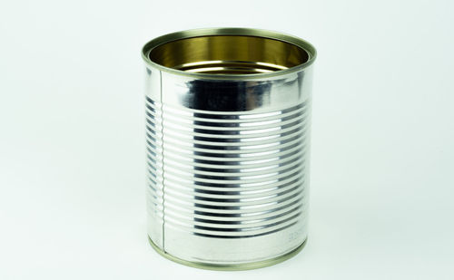 Close-up of glass of jar against white background