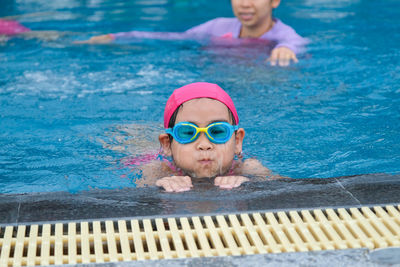 Portrait of boy swimming in pool