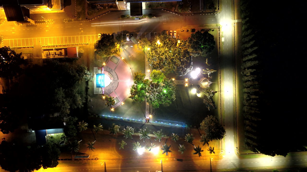 HIGH ANGLE VIEW OF CROWD AT ILLUMINATED CITY BUILDINGS