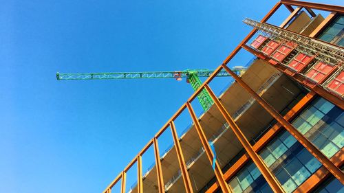 Low angle view of construction site against clear sky