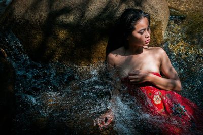 Close-up of young woman in water