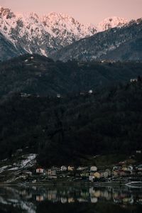 Scenic view of lake by mountains against sky