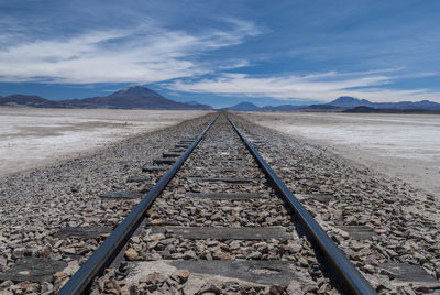 View of railroad track against cloudy sky