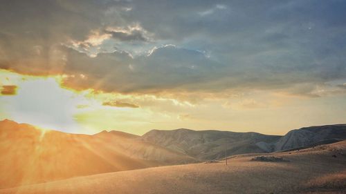 Scenic view of mountains against sky during sunset