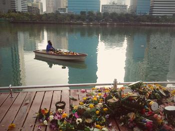 Boats in river with buildings in background