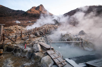 Smoke emitting from hot springs by mountains