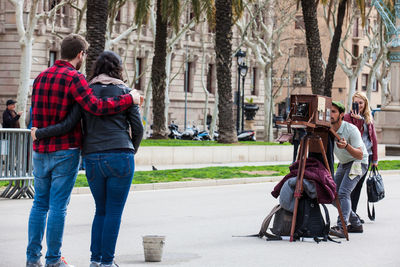 Rear view of couple walking on street