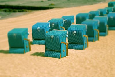 Row of deck chairs on sand