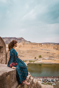 Woman looking at lake and fort in city