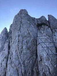 Low angle view of rocky mountains against sky