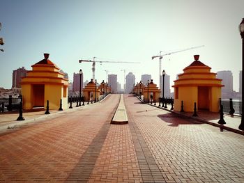 Street amidst buildings against clear sky