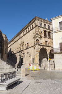 Low angle view of historic building against clear blue sky