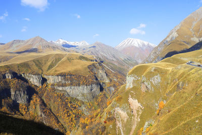 Scenic view of valley and mountains against sky