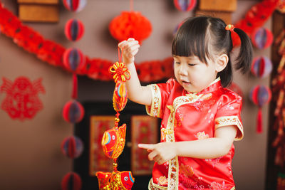 Full length of cute girl standing in traditional clothing