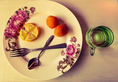 High angle view of fruits in plate on table