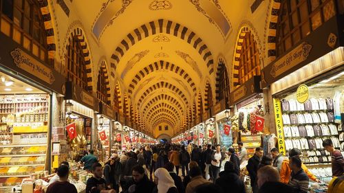 People at illuminated market in city