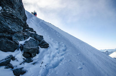 Low angle view of snowcapped mountain against sky