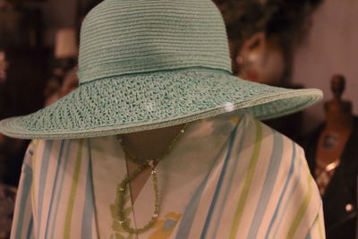 Close-up of mannequin with hat and fabric in store