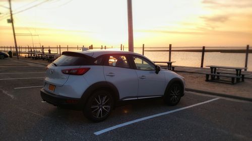 Car on road at sunset