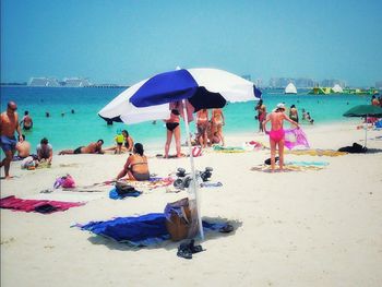 People at beach against sky