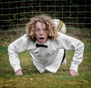 Portrait of teenage boy on playing field