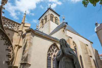 Sculpture of virgin mary against church of saint-eucaire