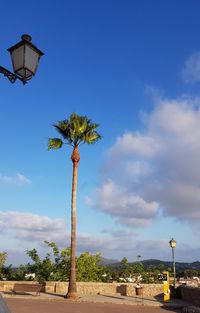 Low angle view of street light against blue sky