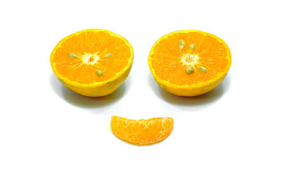 Close-up of orange fruit against white background