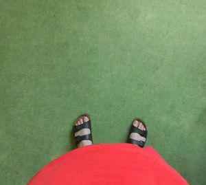 Low section of woman standing on tiled floor