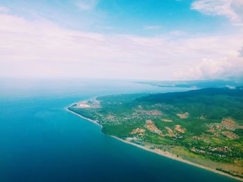 Aerial view of sea against cloudy sky