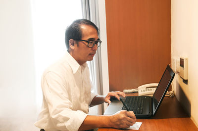 Man using laptop on table