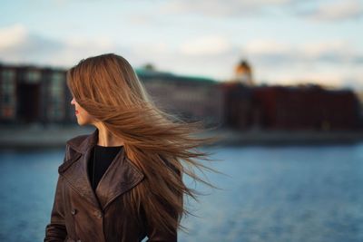 View of woman standing on waterfront