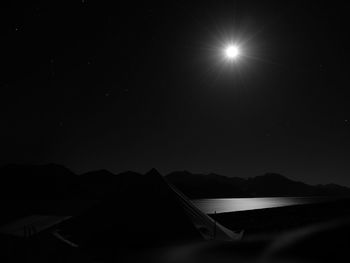 Scenic view of lake against sky at night