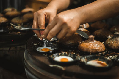 Cropped hands of woman preparing food in kitchen