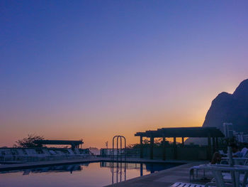 Bridge over river against sky during sunset