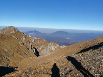 Scenic view of mountains against clear blue sky