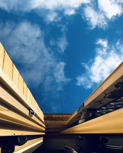 Low angle view of bridge and buildings against sky