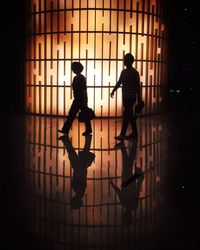 Silhouette men walking in corridor