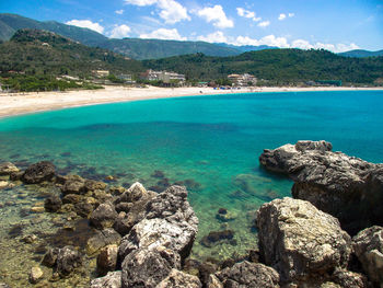 Scenic view of sea and rocks against sky