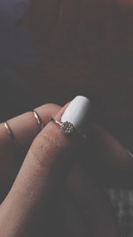 Cropped hand holding ring