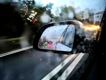 Reflection of car on side-view mirror