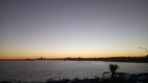 Scenic view of river against clear sky during sunset