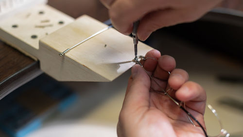 Cropped hand of man working at workshop