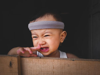 A portrait of a little girl with short hair who was screaming