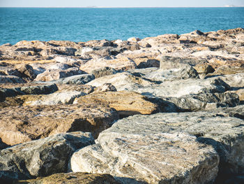 Rocks on beach against sky