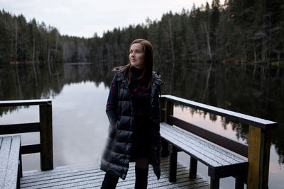Full length of young woman standing in lake