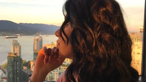 Close-up of young woman looking at cityscape