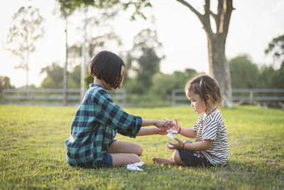 Side view of mother and daughter at park